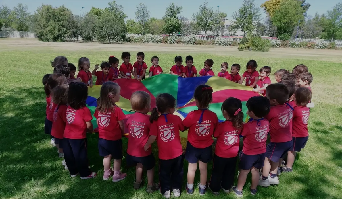 kindergarten children playing with a parachute